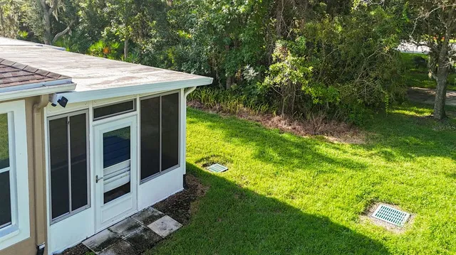 a view of a small house with a yard