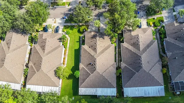 an aerial view of multiple houses with yard