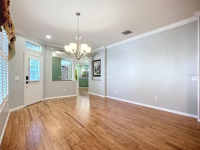 a view of a livingroom with a chandelier fan and window