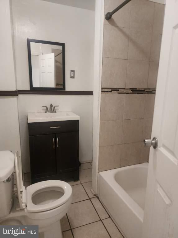 4910 Chestnut Street, Unit 2R Philadelphia, PA 19139 - Photo 4 of 5 a bathroom with a toilet a sink and mirror