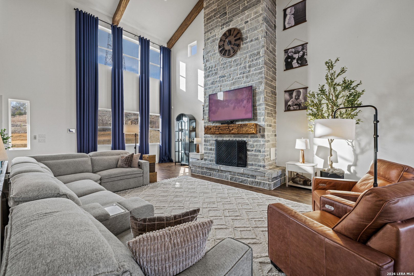 97 Coleman Springs Boerne, TX 78006 - Photo 22 of 86 a living room with furniture a fireplace and a flat screen tv