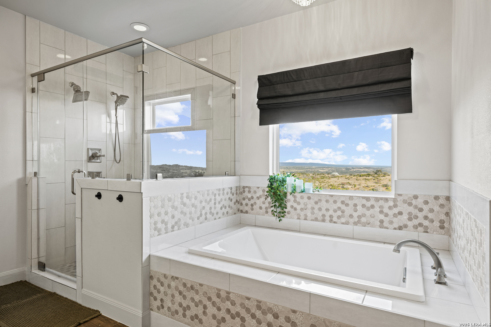 97 Coleman Springs Boerne, TX 78006 - Photo 44 of 86 a bathroom with a bathtub a shower and a window