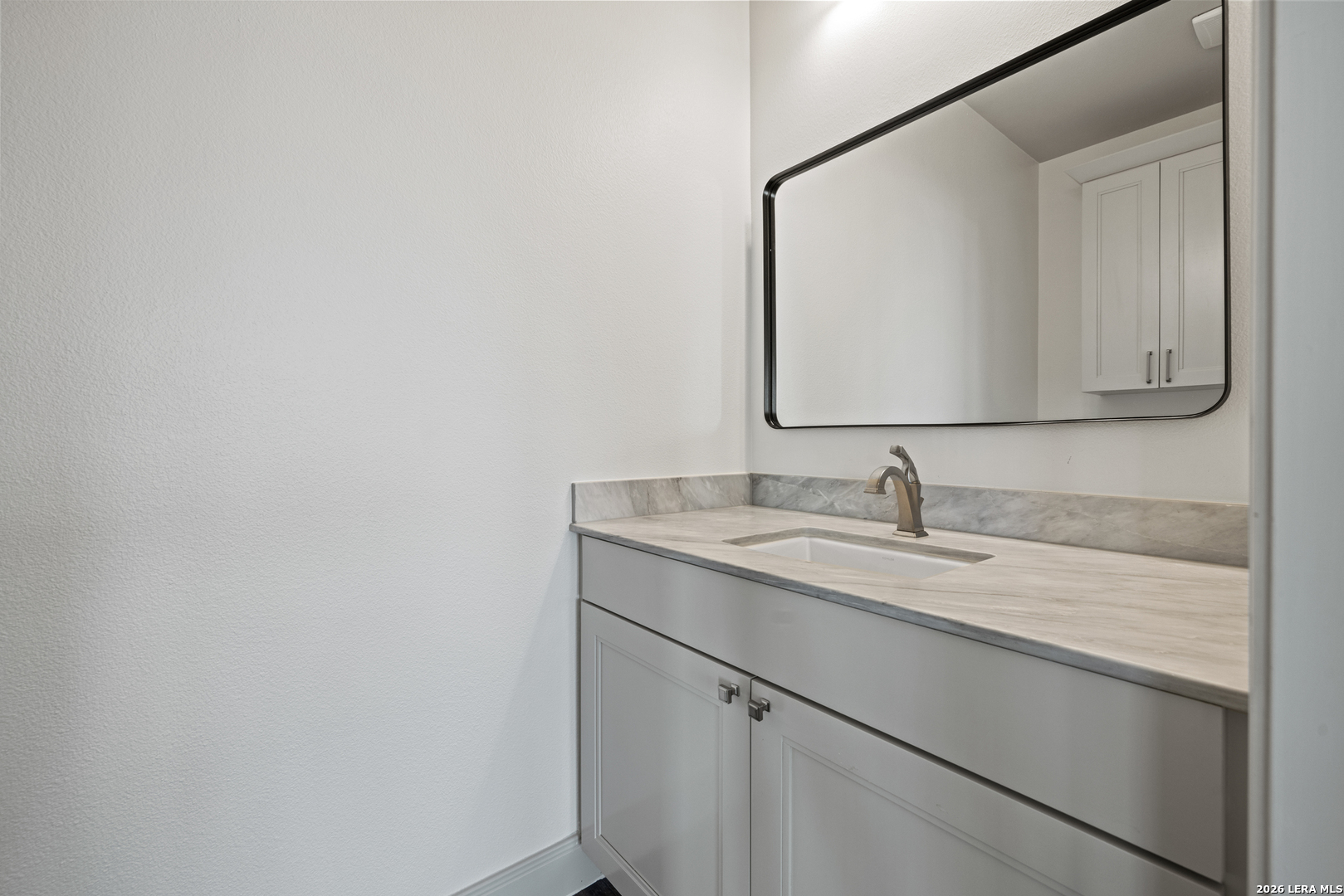 97 Coleman Springs Boerne, TX 78006 - Photo 52 of 86 a bathroom with a granite countertop sink and a mirror