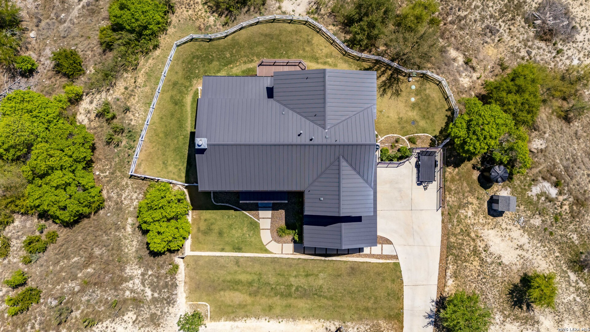 97 Coleman Springs Boerne, TX 78006 - Photo 56 of 86 an aerial view of a house with swimming pool and large trees