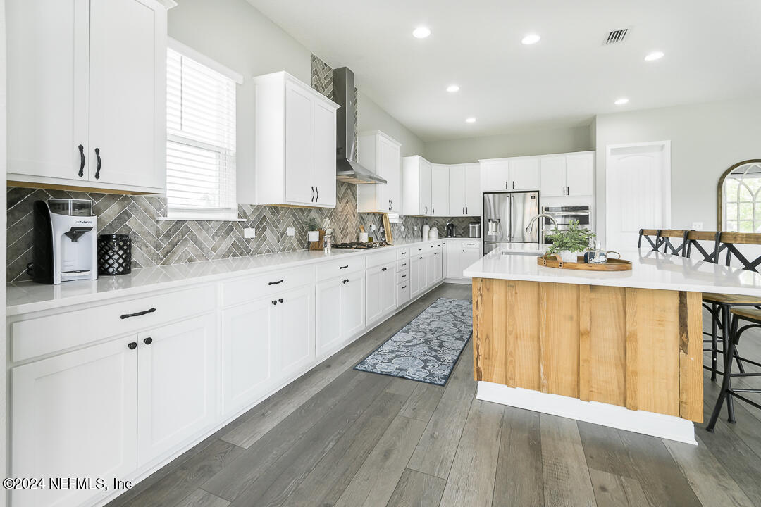 36 Leafmore Lane St. Augustine, FL 32092 - Photo 11 of 38 a large kitchen with stainless steel appliances kitchen island granite countertop a sink a stove a counter space and cabinets