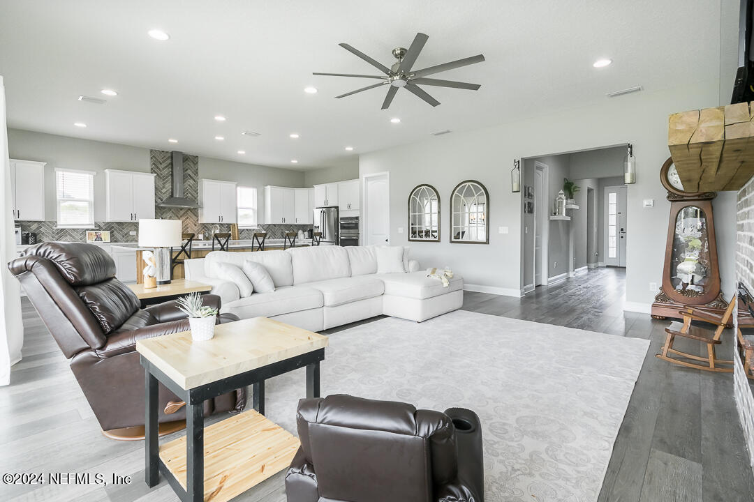 36 Leafmore Lane St. Augustine, FL 32092 - Photo 37 of 38 a living room with furniture a rug and kitchen view