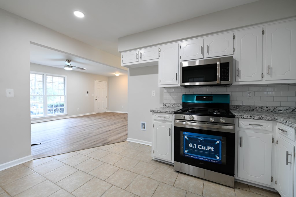 718 Wedron Drive Columbus, GA 31907 - Photo 23 of 38 a kitchen with stainless steel appliances granite countertop a stove a microwave and a refrigerator