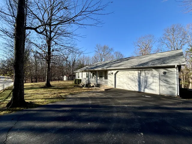 a view of a yard with large trees