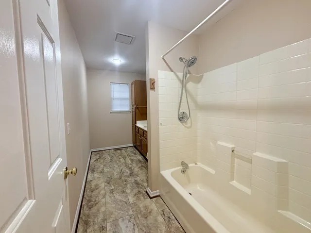 a bathroom with a granite countertop sink a toilet and shower