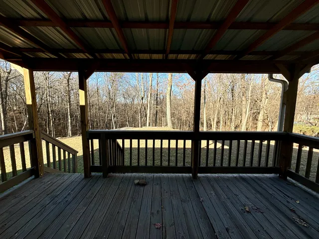 a view of porch with wooden floor