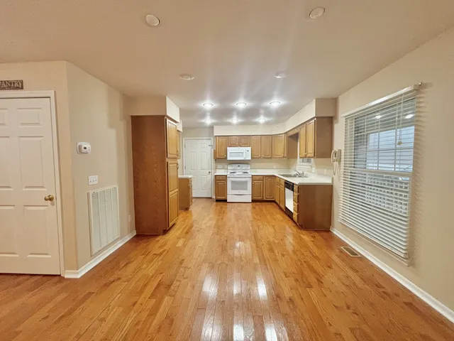 a view of a kitchen with wooden floor