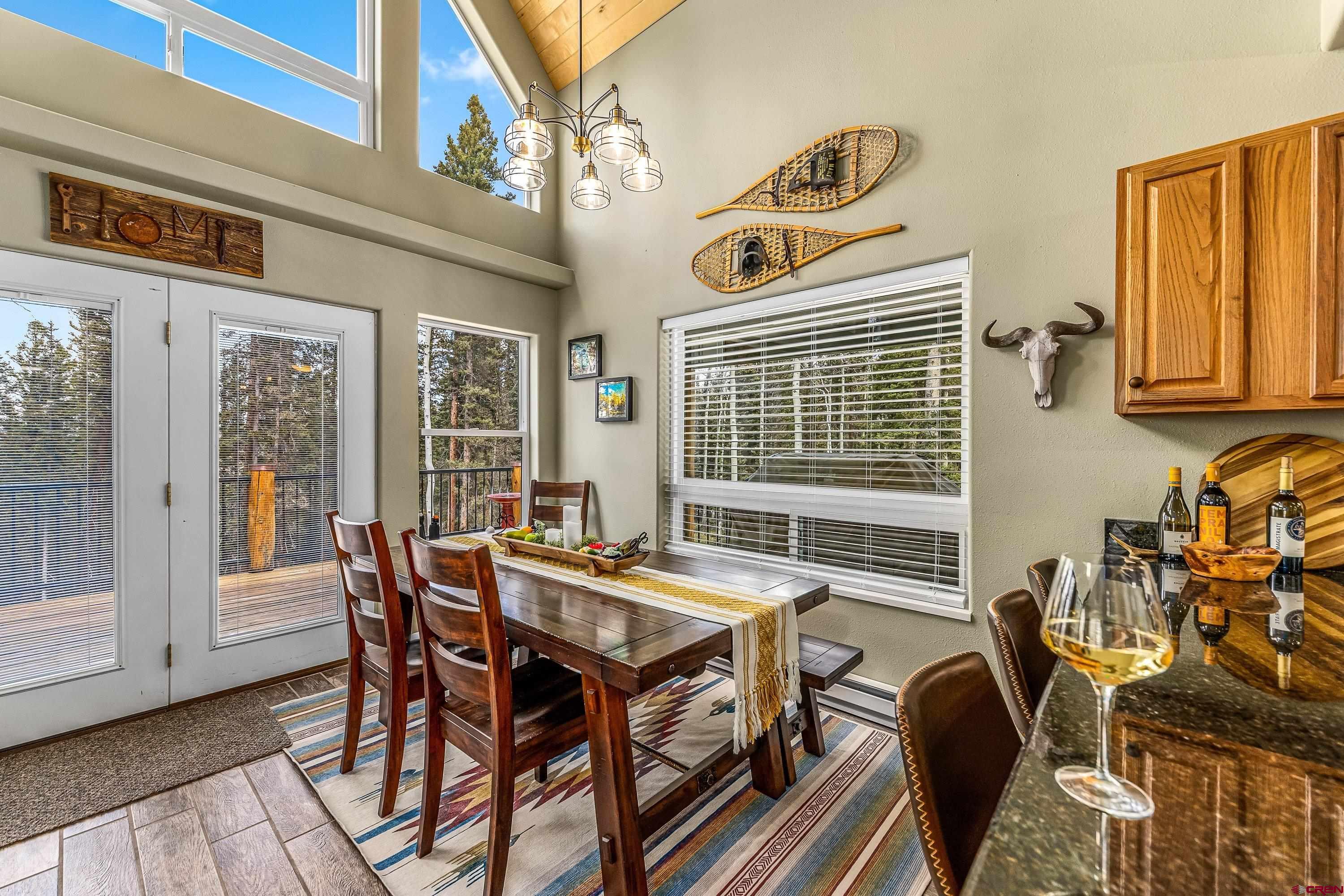 303 Spruce Road Cimarron, CO 81220 - Photo 13 of 35 a view of a dining room with furniture window and outside view