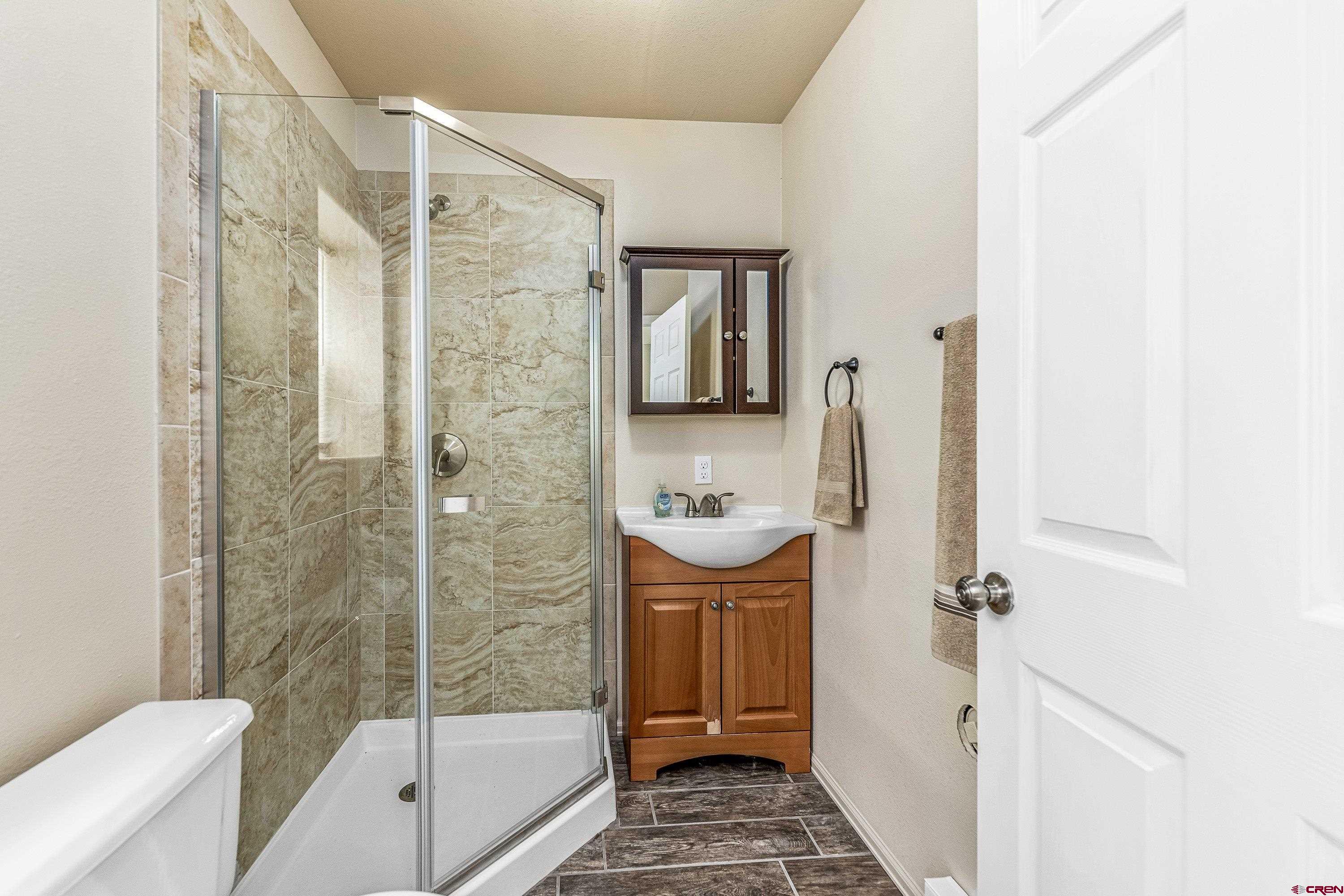 303 Spruce Road Cimarron, CO 81220 - Photo 18 of 35 a bathroom with a shower and a sink