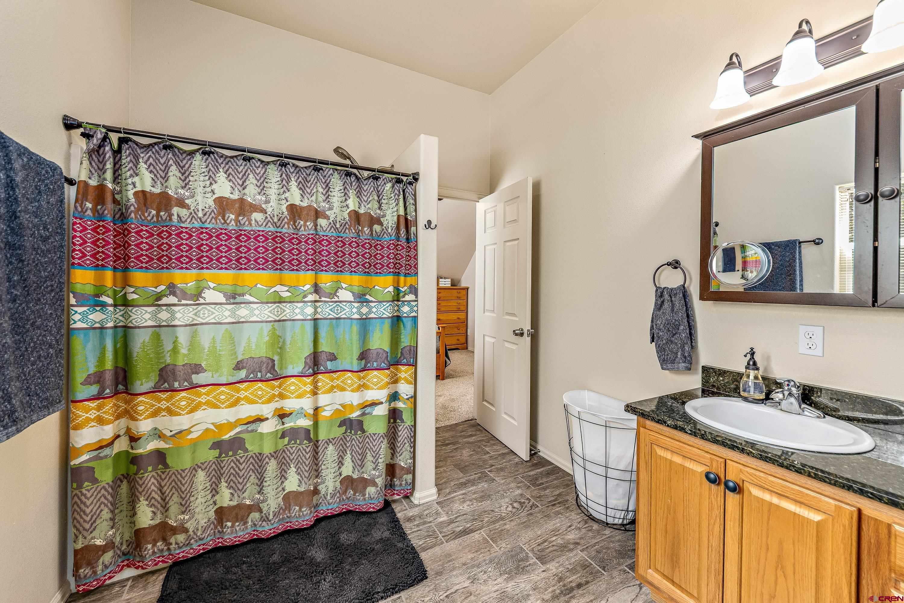 303 Spruce Road Cimarron, CO 81220 - Photo 29 of 35 a bathroom with a tub sink and mirror