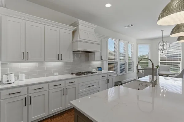 a open kitchen with stainless steel appliances granite countertop a lot of counter space and a wooden floors