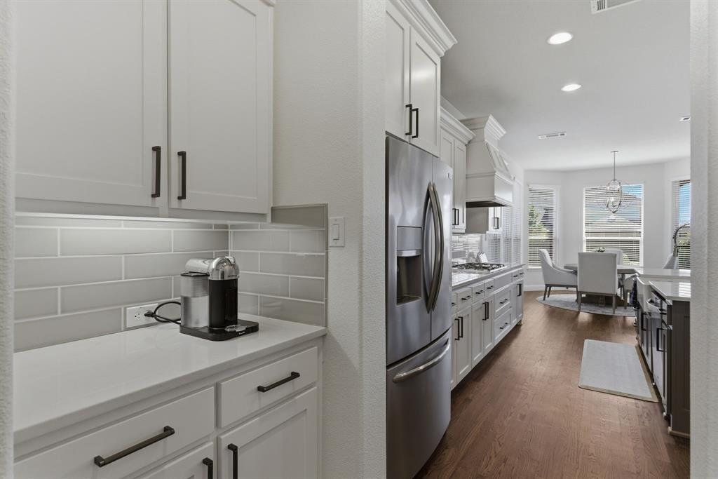 2801 Seabiscuit Road Celina, TX 75009 - Photo 11 of 39 a kitchen with stainless steel appliances a refrigerator a sink and white cabinets