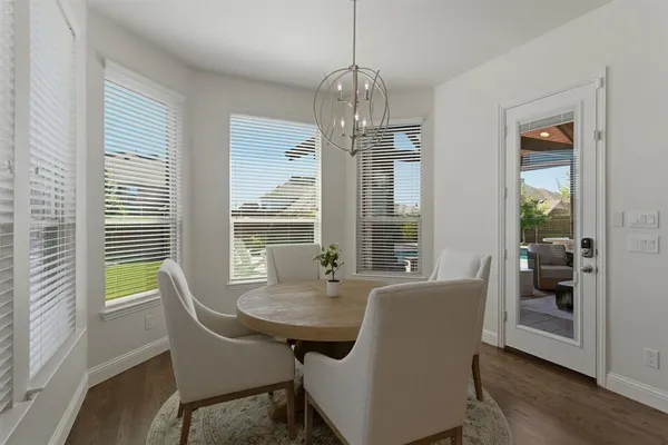 a kitchen with stainless steel appliances a refrigerator a sink and white cabinets