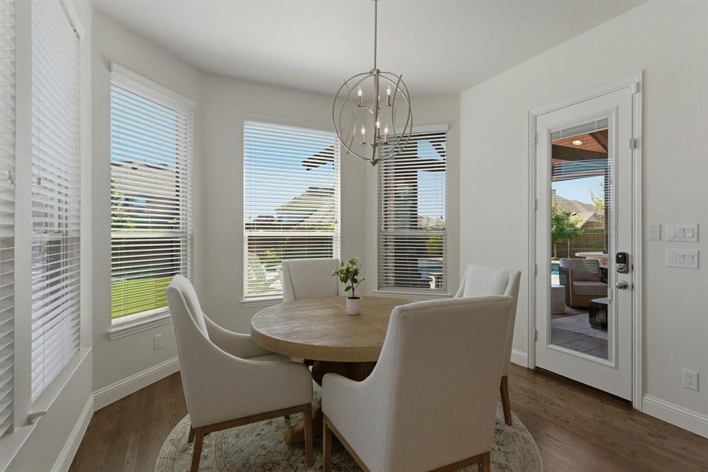2801 Seabiscuit Road Celina, TX 75009 - Photo 12 of 39 a view of a dining room with furniture window and wooden floor