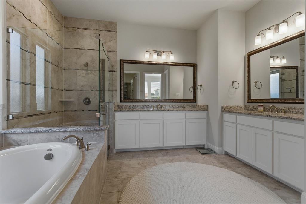 2801 Seabiscuit Road Celina, TX 75009 - Photo 17 of 39 a bathroom with a granite countertop tub sink and mirror