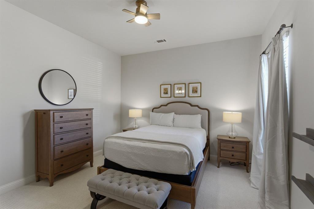 2801 Seabiscuit Road Celina, TX 75009 - Photo 18 of 39 a bedroom with a bed and a chandelier