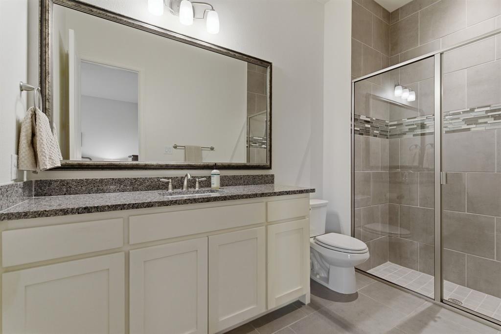 2801 Seabiscuit Road Celina, TX 75009 - Photo 19 of 39 a bathroom with a granite countertop sink mirror and toilet