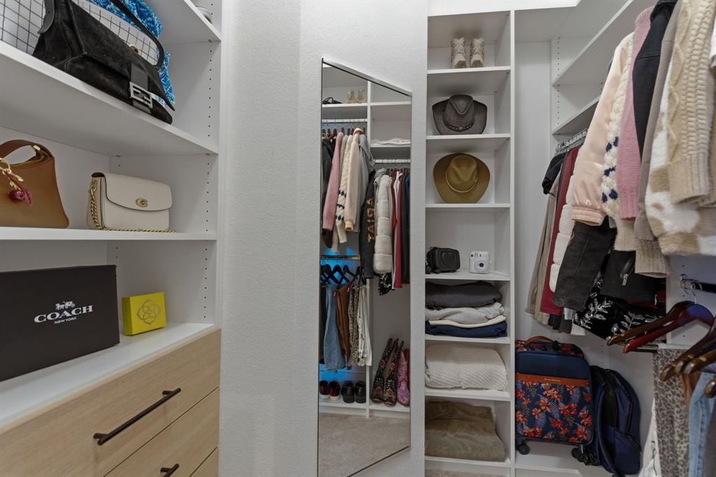2801 Seabiscuit Road Celina, TX 75009 - Photo 29 of 39 a view of walk in closet with clothes and shoes