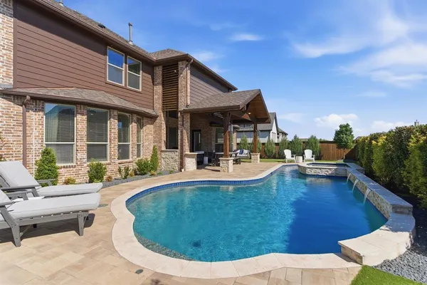 a view of a house with swimming pool and sitting area