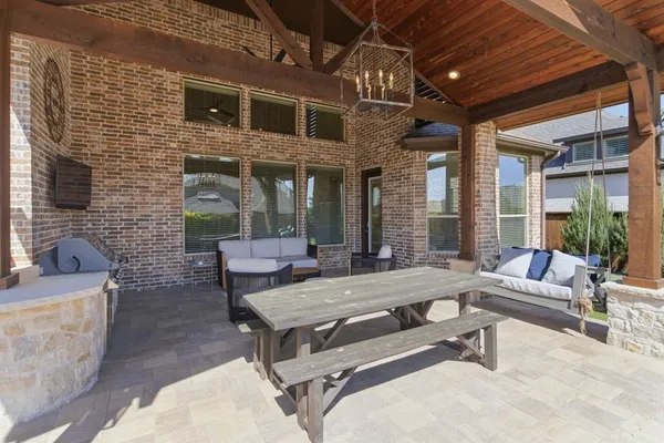 a view of a house with swimming pool and sitting area
