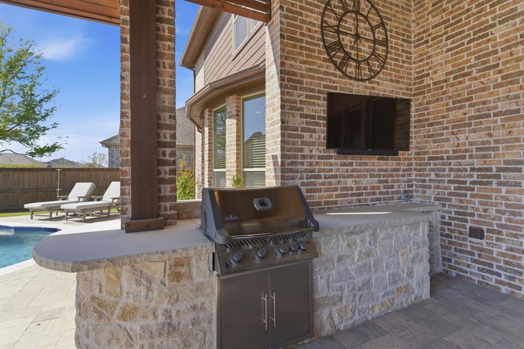 2801 Seabiscuit Road Celina, TX 75009 - Photo 35 of 39 a brick house with a stove and a table
