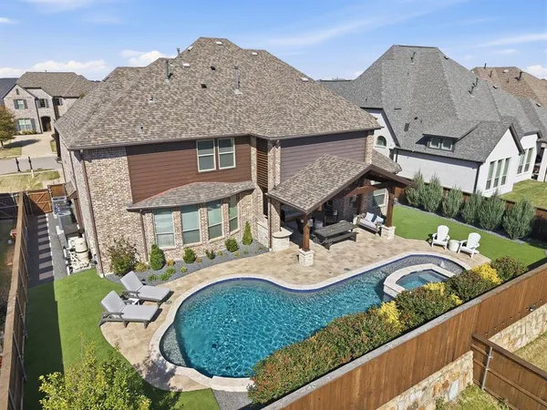 an aerial view of a house with a swimming pool