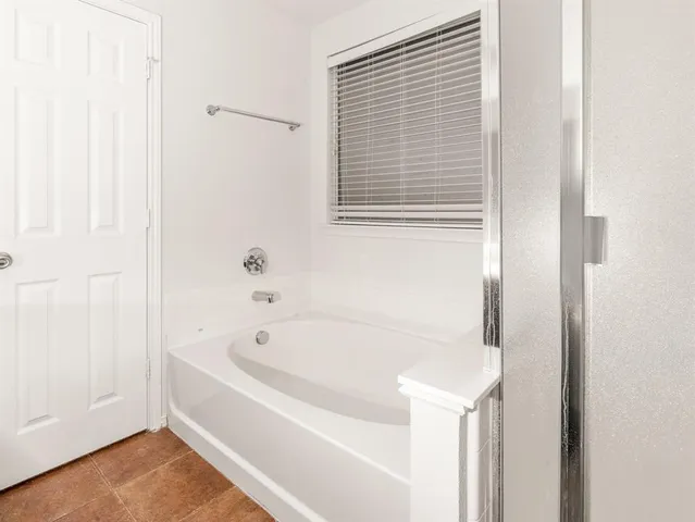 a white bath tub sitting next to a window