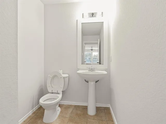 a close view of a toilet sink and mirror in a bathroom