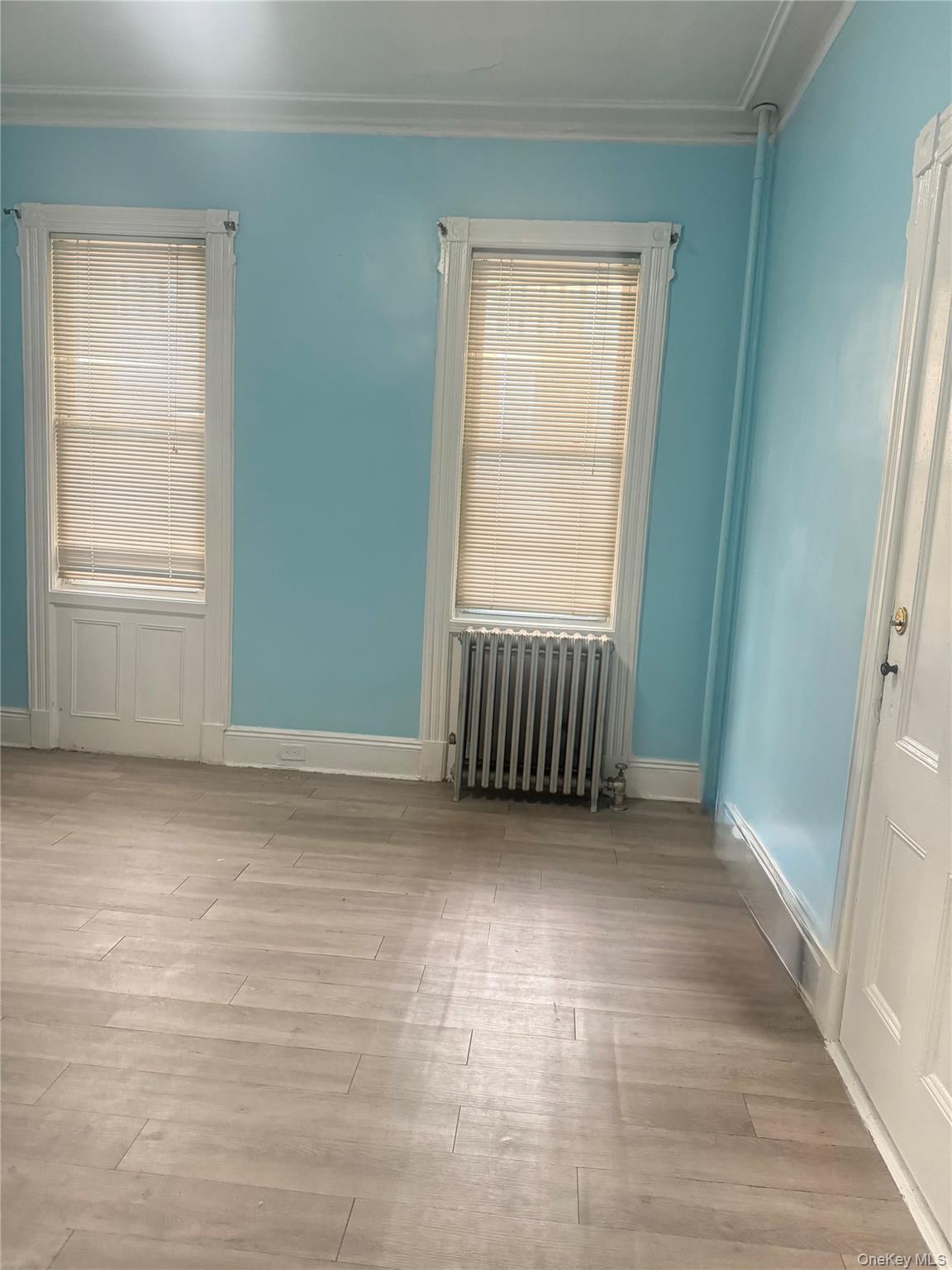 68-13 60th Street Queens, NY 11385 - Photo 12 of 27 an empty room with windows