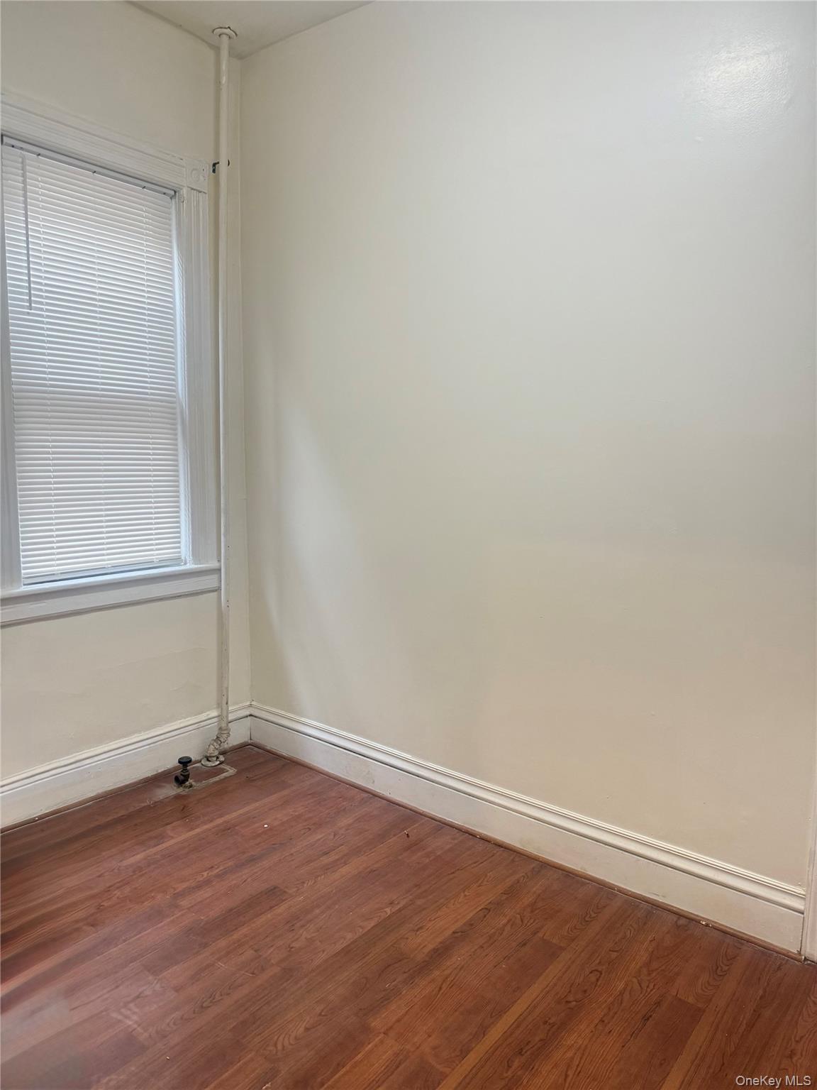 68-13 60th Street Queens, NY 11385 - Photo 15 of 27 a view of a small space with wooden floor and a window