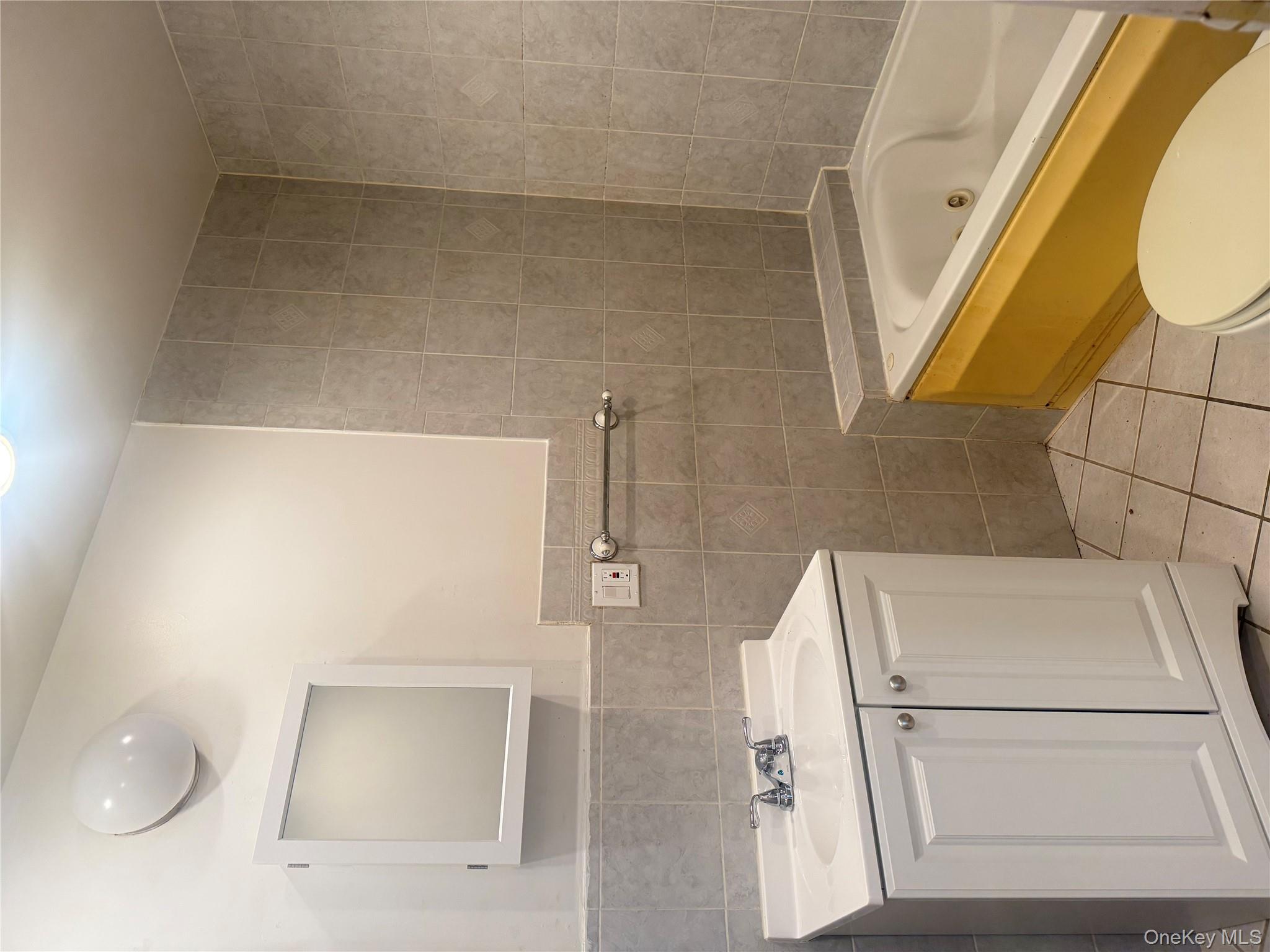 68-13 60th Street Queens, NY 11385 - Photo 16 of 27 a bathroom with a sink a toilet and bathtub