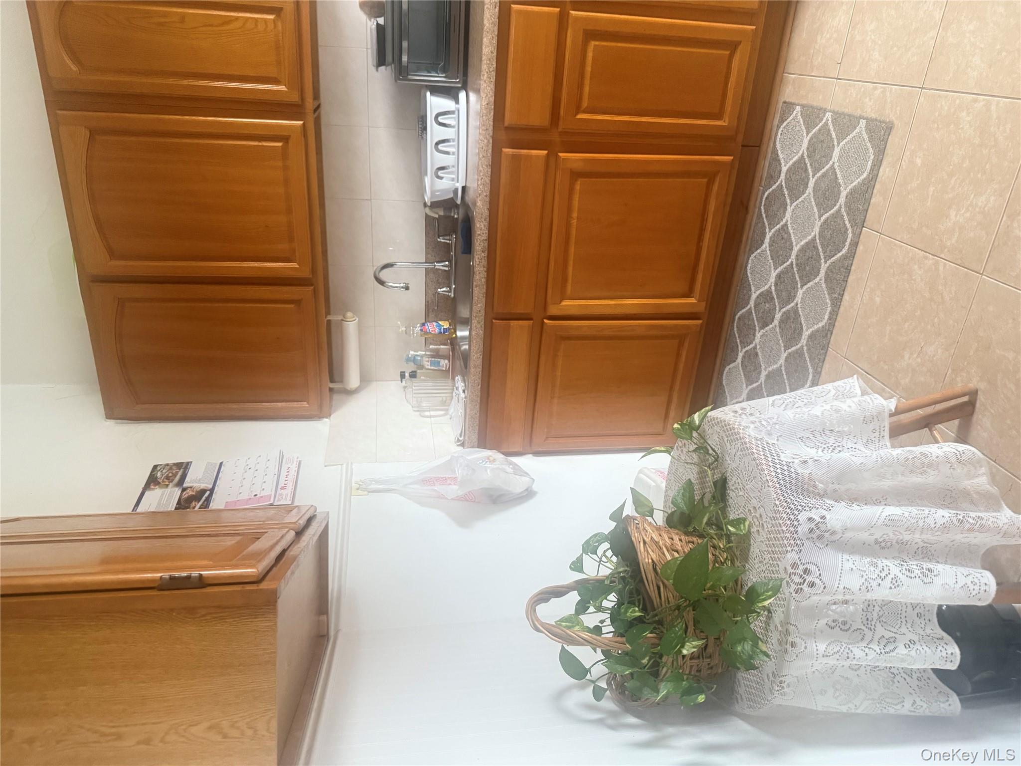 68-13 60th Street Queens, NY 11385 - Photo 18 of 27 a kitchen with a sink and cabinets