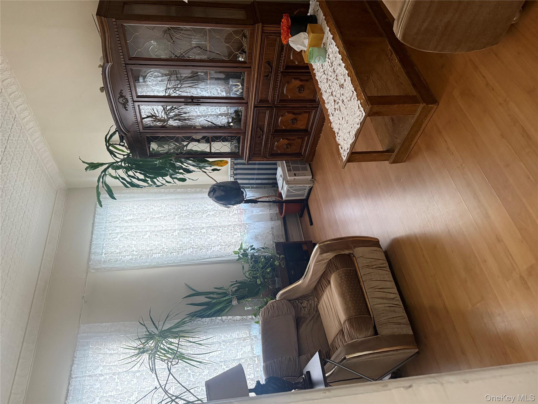 68-13 60th Street Queens, NY 11385 - Photo 20 of 27 a living room with furniture and a large window