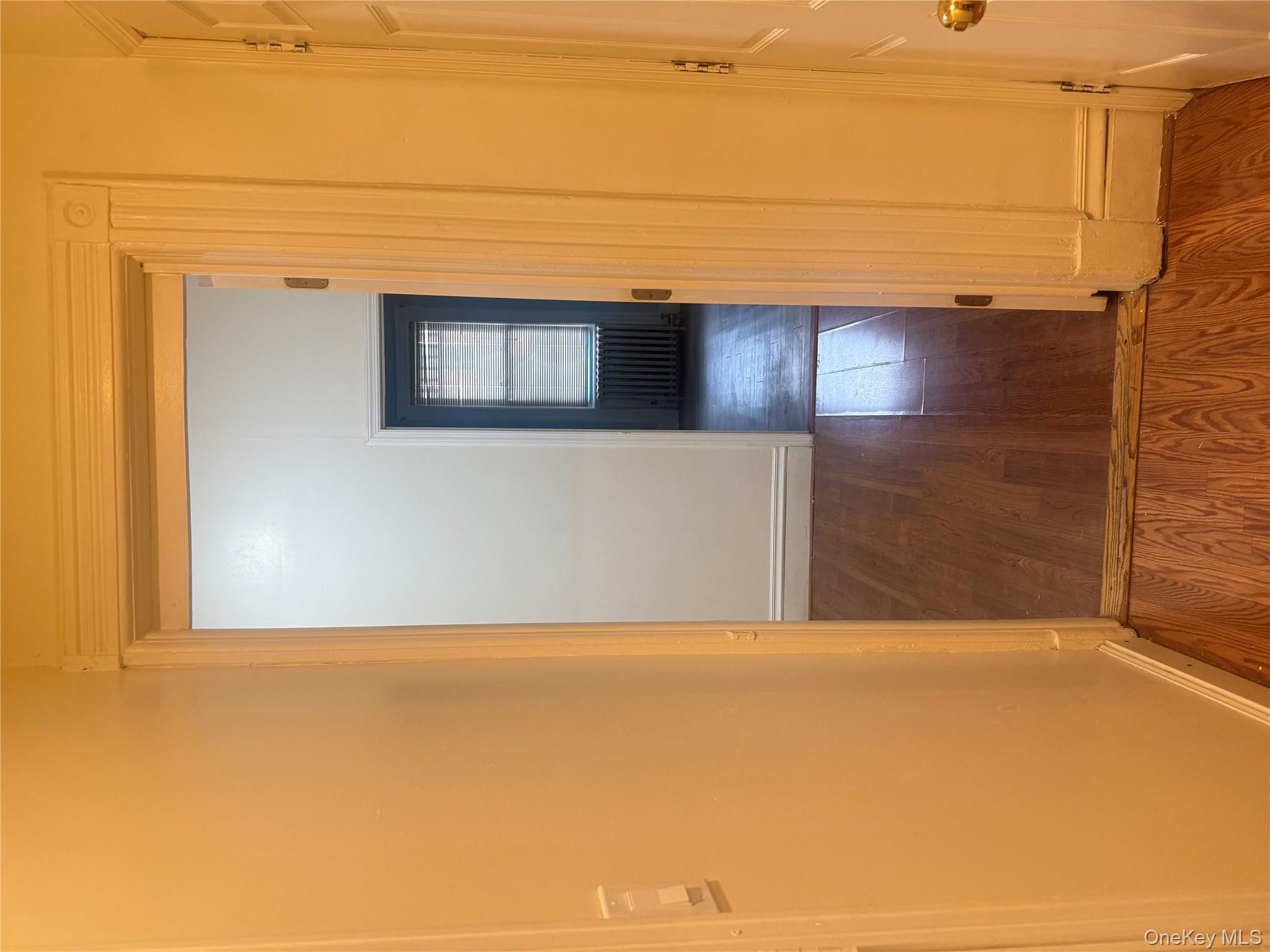 68-13 60th Street Queens, NY 11385 - Photo 21 of 27 a view of hallway with wooden floor