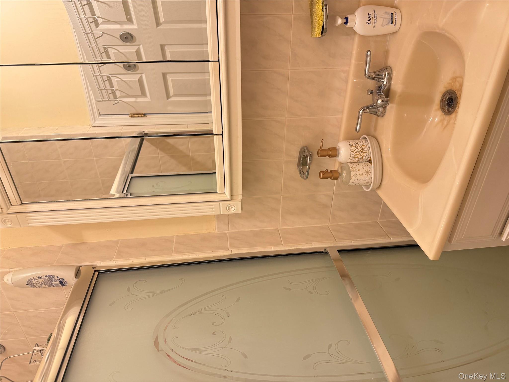 68-13 60th Street Queens, NY 11385 - Photo 22 of 27 a bathroom with a sink and a window