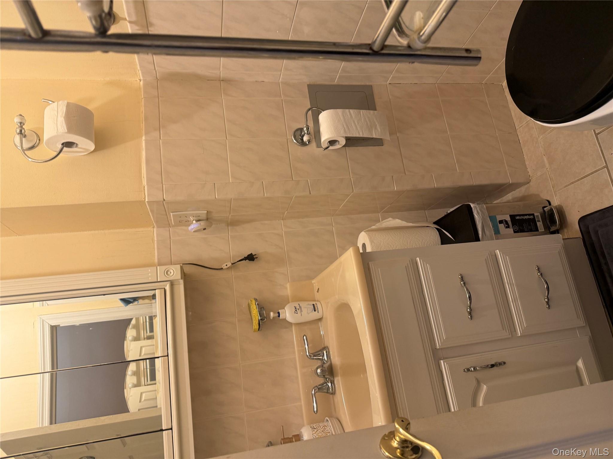 68-13 60th Street Queens, NY 11385 - Photo 23 of 27 a bathroom with a sink a toilet and a mirror
