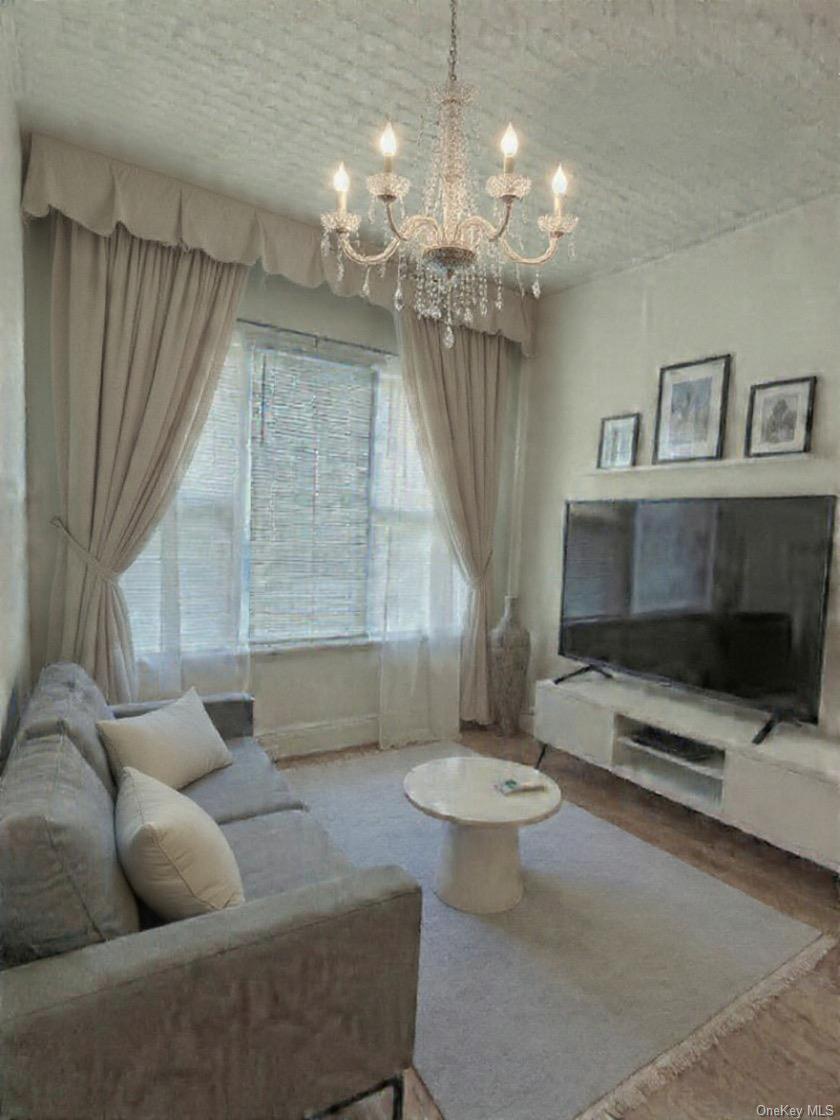 68-13 60th Street Queens, NY 11385 - Photo 7 of 27 a living room with furniture a table and a chandelier