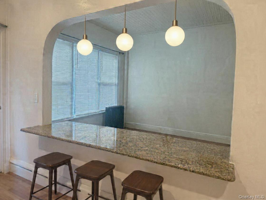 68-13 60th Street Queens, NY 11385 - Photo 9 of 27 a kitchen with a table and chairs in it