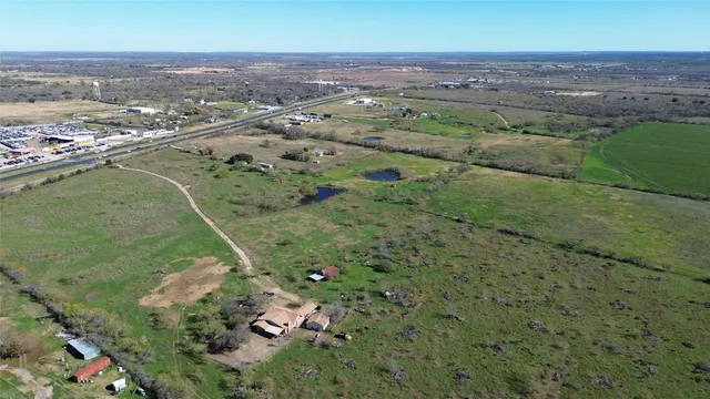 an aerial view of a houses with a yard