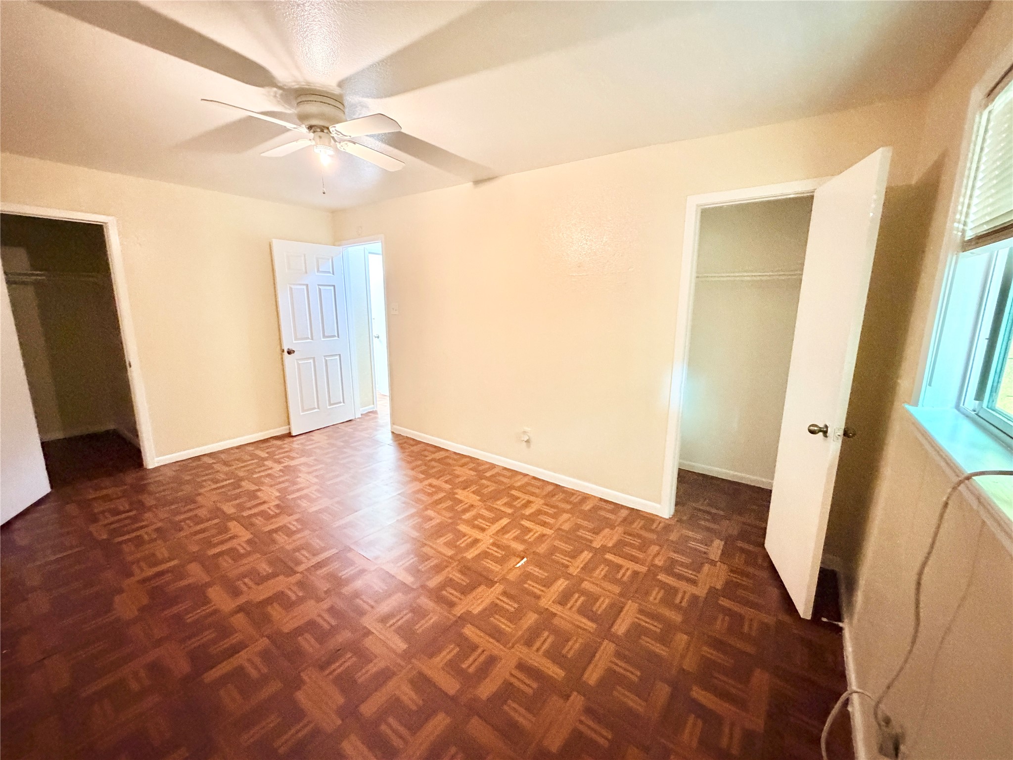 6257 Manor Road, Unit B Austin, TX 78723 - Photo 21 of 38 Interior room featuring wood-finish parquet flooring and neutral wall tones