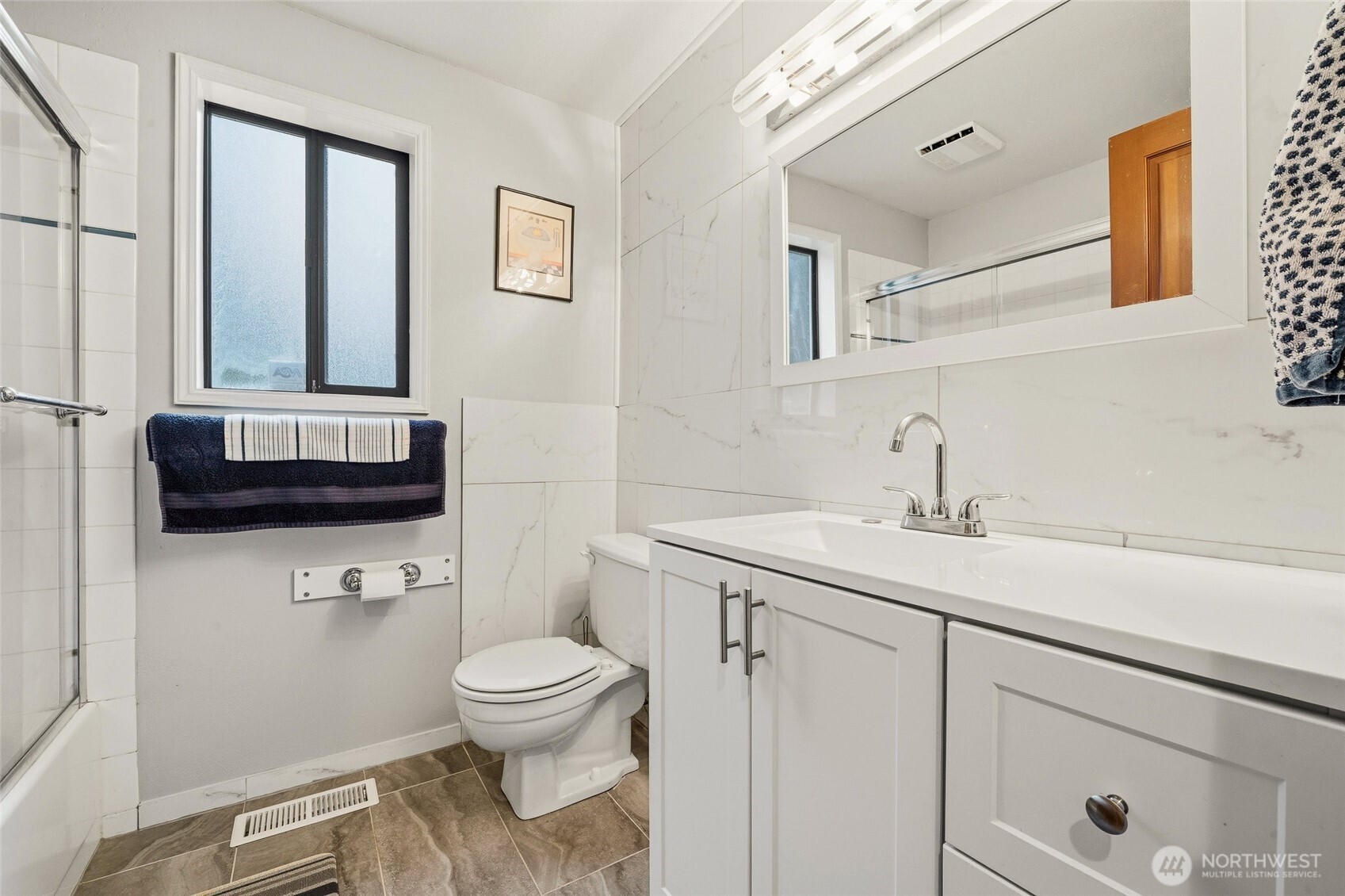 6830 Norma Beach Road Edmonds, WA 98026 - Photo 18 of 30 a bathroom with a toilet a sink and a mirror
