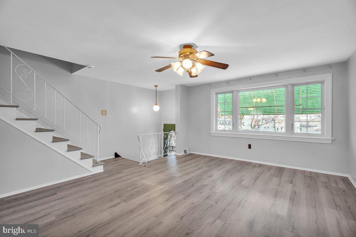 3639 Gaul Street Philadelphia, PA 19134 - Photo 6 of 23 a view of an empty room with a window and wooden floor
