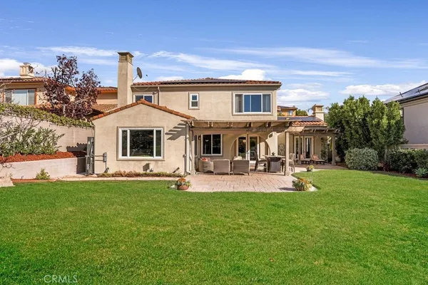 a front view of a house with swimming pool yard and patio