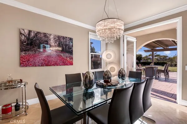 a view of a dining room with furniture wooden floor and chandelier