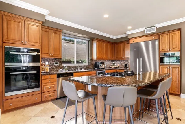 a dining room with furniture a chandelier and window