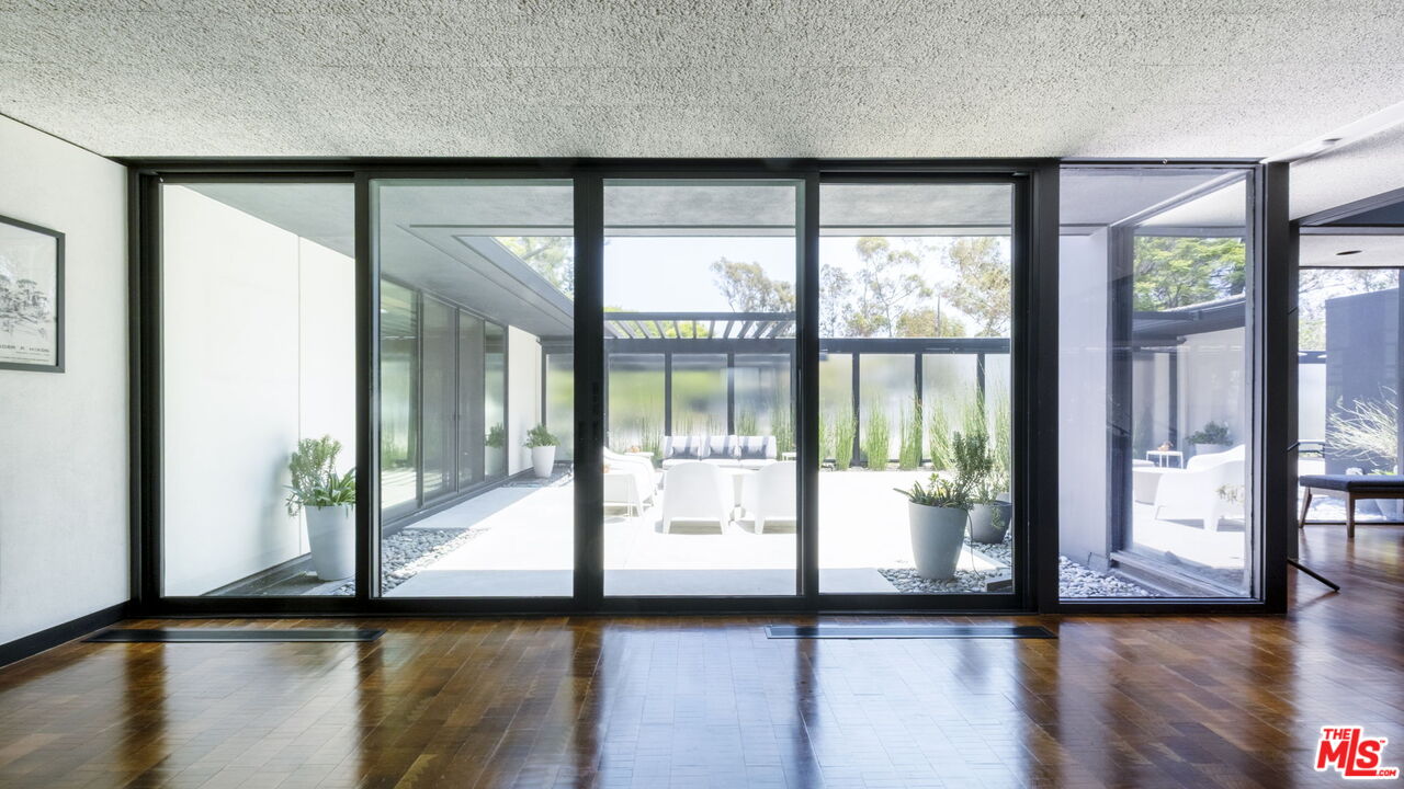 1100 Paso Alto Road Pasadena, CA 91105 - Photo 11 of 21 a view of empty room with wooden floor and floor to ceiling window